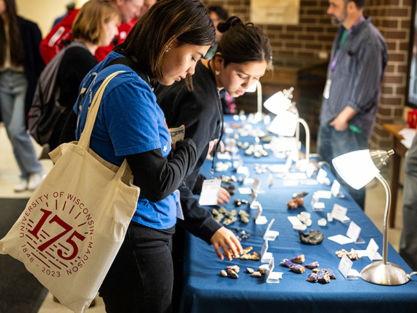 Visitors look at and purchase small rocks, minerals and fossils as part of a fund-raising event for the Geology Museum during an open house.