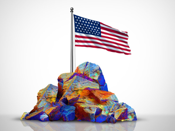 A conceptual rendering of rare earth elements in a rock pile, with a U.S. flag on top of it.