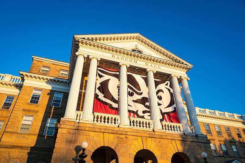 Bascom Hall, featuring Bucky Badger banners, is pictured during sunrise