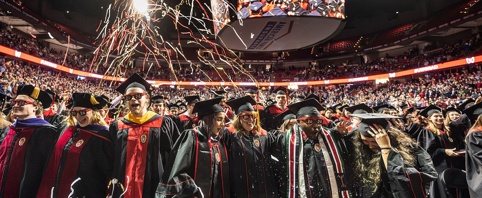 Graduates celebrate and streamers add to the festive atmosphere at the conclusion of the winter commencement ceremony.