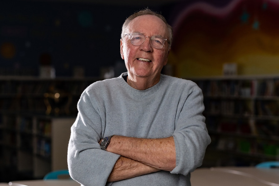James Patterson smiles in a school classroom