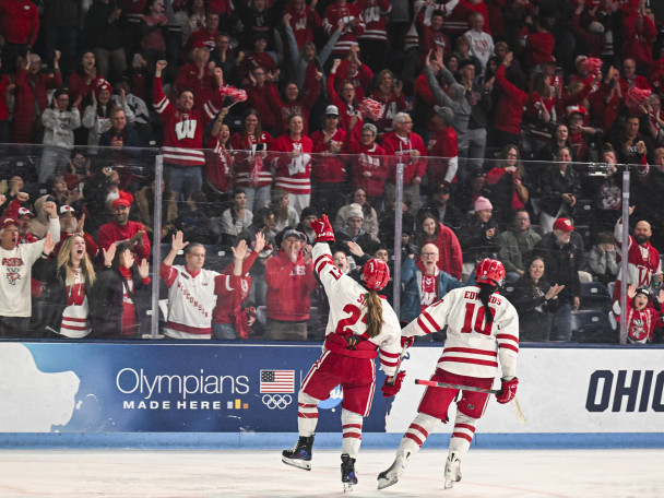 From the ice, players Kirsten Simms and Laila Edwards acknowledge the Badger fans in the stands after Edwards scored a goal.