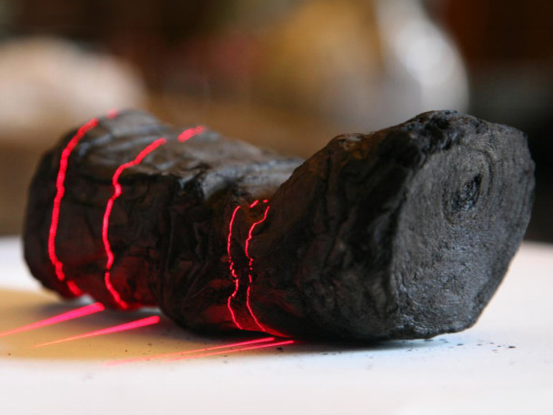 A lump of char roughly in the shape of a scroll is scanned.