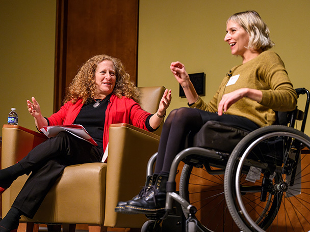 Chancellor Mnookin sits on stage with Rebekah Taussig, who uses a wheelchair, as they discuss Taussig's book Sitting Pretty.