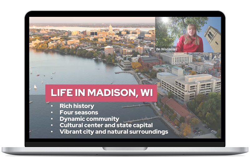 Laptop with a girl speaking on the screen, a picture of the city of Madison behind her.